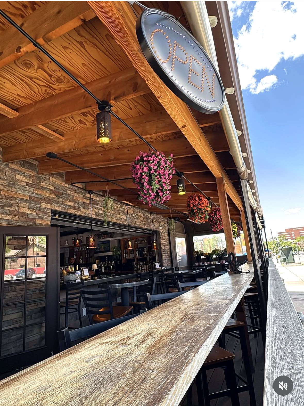 Mila's Cantina covered patio with OPEN sign and hanging flowers on 6th Avenue